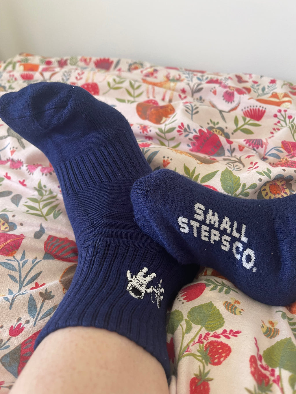 Navy Small Steps Co. bamboo socks with Small Steps Co. woven on the sole