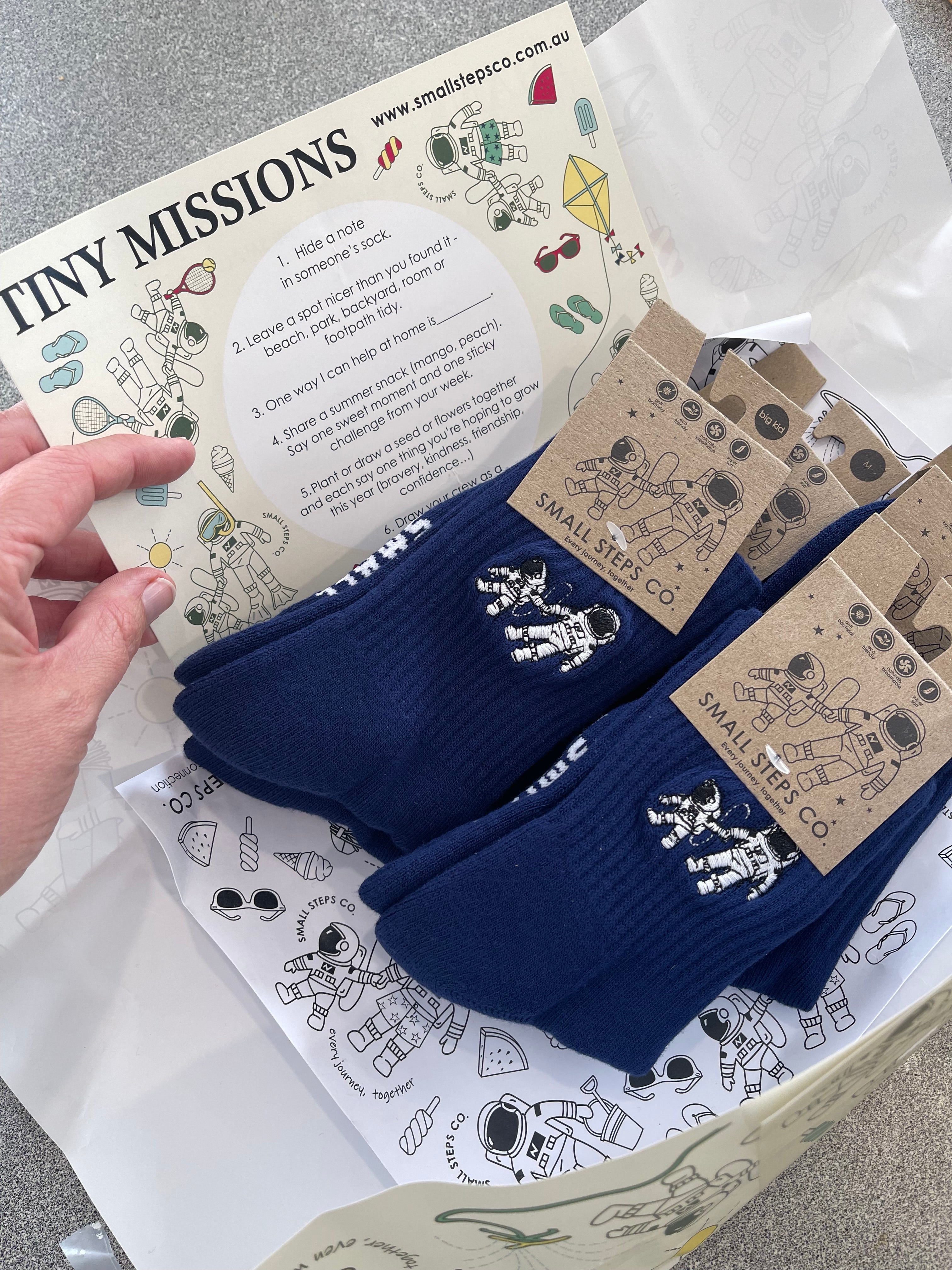 Small Steps Co. gift box with Tiny Missions activity card and navy socks