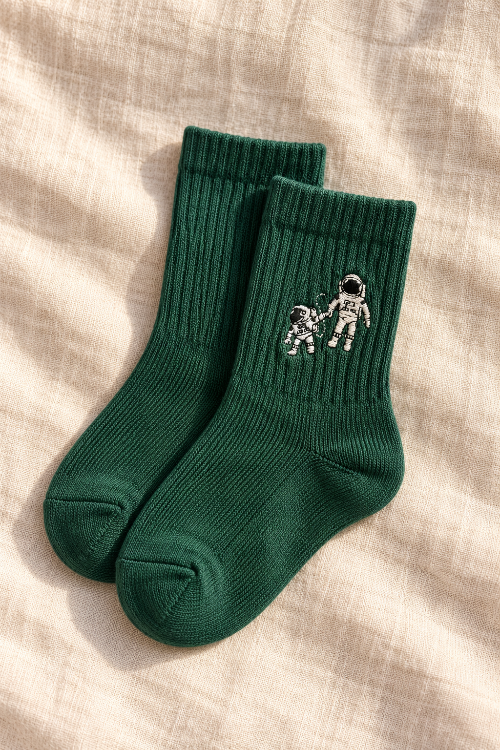 Small Steps Co. little kids deep green bamboo crew socks with astronaut emblem