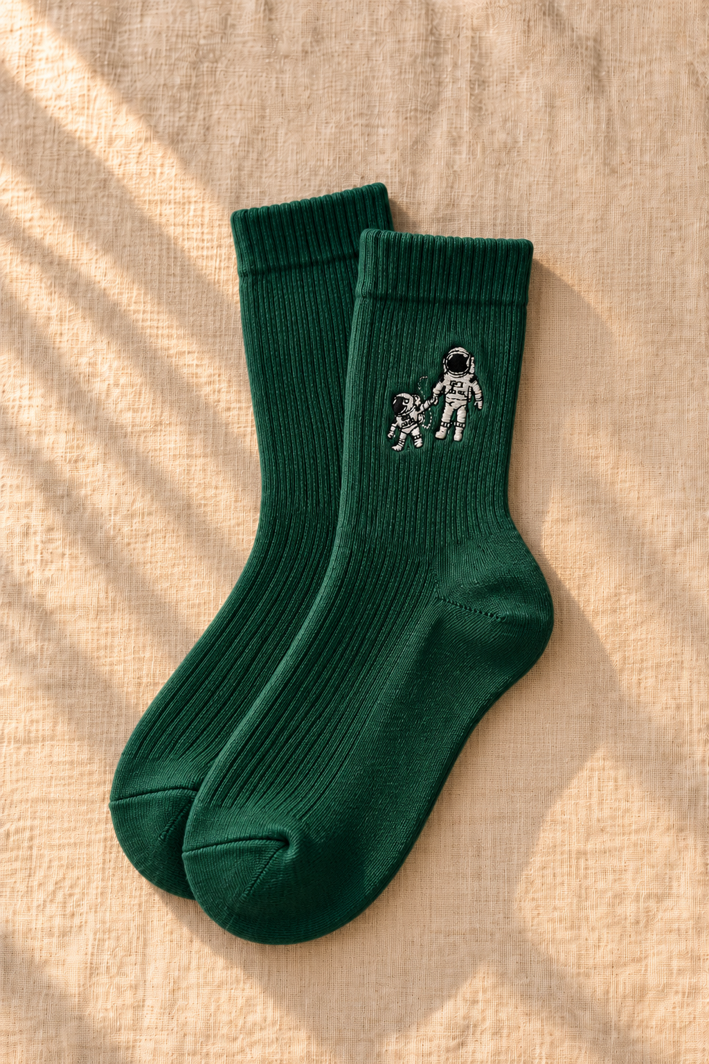 Small Steps Co. women's deep green bamboo crew socks with astronaut emblem